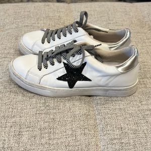 White tennis shoes with black star. In good condition. Only worn a few times